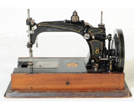 A 19th century circa 1870s American sewing machine by Wheeler &amp; Wilson, model # 8, serial # 195485.&nbsp; Presented in it