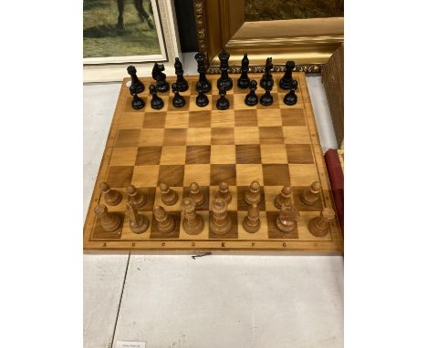 A WOODEN CHESS SET WITH FOLD AWAY BOARD - COMPLETE 