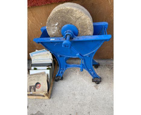 A VINTAGE SANDSTONE GRIND STONE WITH CAST IRON BASE 