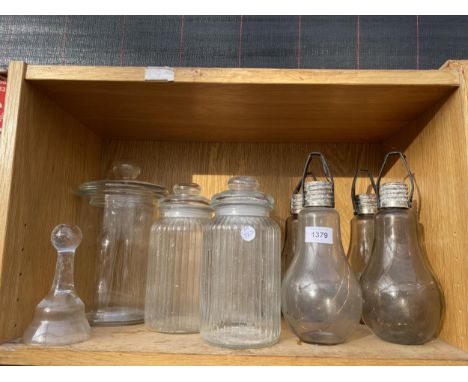 AN ASSORTMENT OF GLASS STORAGE JARS AND GLASS LIGHTS IN THE FORM OF A LIGHT BULB ETC 