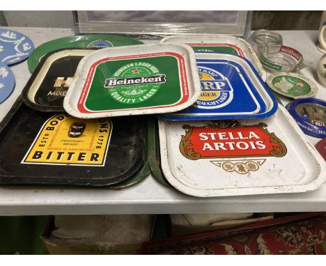 A LARGE AMOUNT OF BREWERY RELATED TRAYS AND ASHTRAYS TO INCLUDE STELLA, HARP, BODDINGTONS, HEINEKEN, WHITBREAD, ETC 