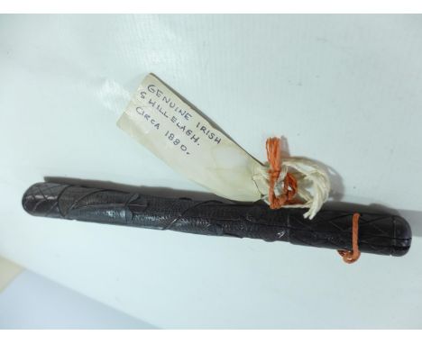A LATE 19TH/EARLY 20TH CENTURY IRISH BOG OAK CLUB/SHILLELAGH, 34CM LONG WITH CARVED DECORATION OF SHAMROCKS AND AN IRISH HARP