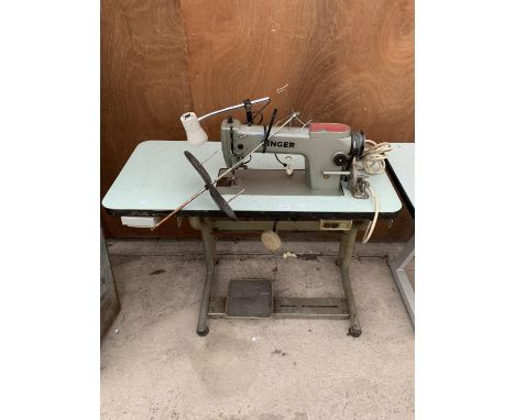 A VINTAGE SINGER INDUSTRIAL SEWING MACHINE WITH TREADLE BASE 