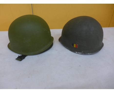 A GERMAN HELMET AND LINER AND A FURTHER METAL HELMET 