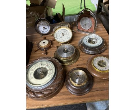 A LARGE AMOUNT OF WOODEN AND BRASS BAROMETERS PLUS AN ALARM CLOCK IN THE GUISE OF A POCKET WATCH 