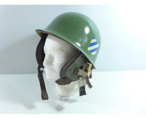 A GREEN PAINTED METAL HELMET AND LINER AND EAR PIECES 