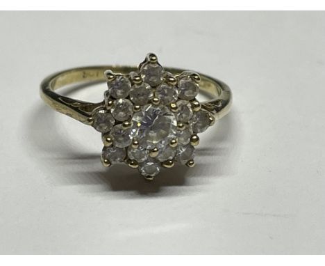 A 9 CARAT GOLD RING WITH CUBIC ZIRCONIAS SET IN A FLOWER DESIGN SIZE K/L 