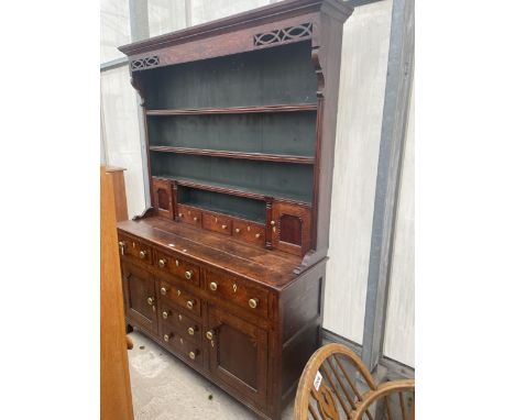 A GEORGE III OAK DRESSER, THE BASE ENCLOSING THREE LONG AND THREE SHORT DRAWERS AND TWO CUPBOARDS, THE UPPER PORTION ENCLOSIN