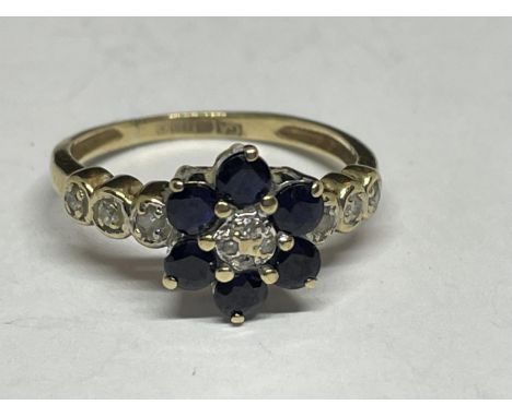 A 9 CARAT GOLD RING WITH SAPPHIRES AND DIAMONDS IN A FLOWER DESIGN AND DIAMONDS ON THE SHOULDERS SIZE K 