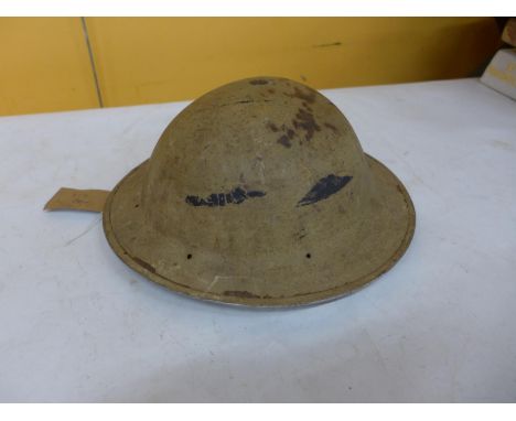 A WORLD WAR II DESERT COLOURED PAINTED BRODIE HELMET AND LINEN 