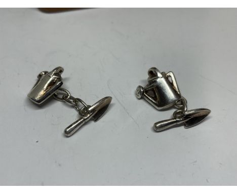 A PAIR OF SILVER CUFFLINKS WITH A WATERING CAN AND TROWEL DESIGN 