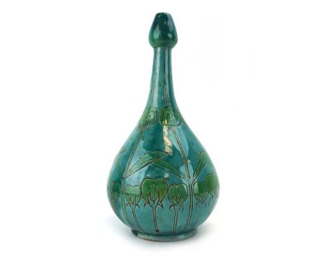 Charles Collis for Della Robbia, a terracotta bottle vase incised with carnations and decorated in a plain pale green glaze, 