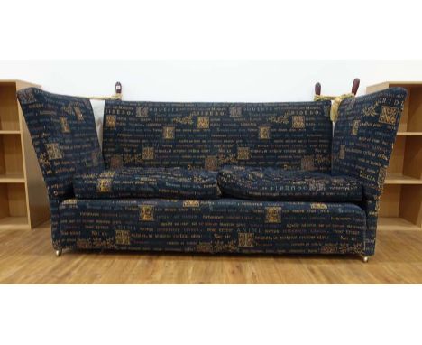 A contemporary knole sofa with blue upholstery, mahogany handles and swags