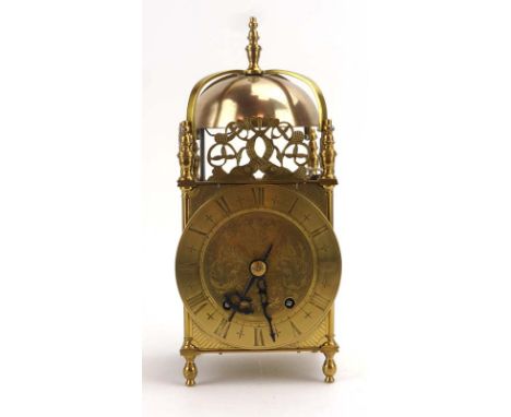 An English reproduction lantern clock, the bell striking on the hour and half hour, within a brass case of typical form, h. 3