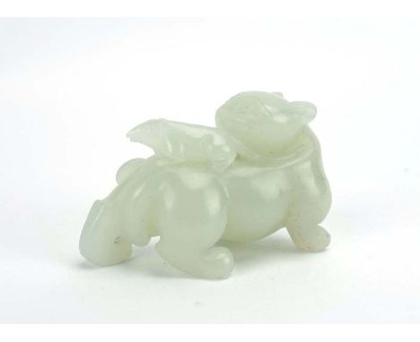 A Chinese celadon jade carving modelled as a feline creature, a rat on its back, h. 3.5 cm