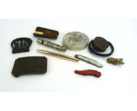 A Wells Fargo and Company belt buckle, a cased silver mounted amber cheroot, a brass container modelled as a pig, a moulded b