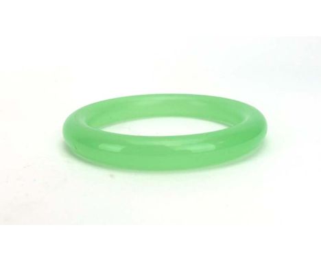 A pale green jade bangle, internal d. 5.9 cm