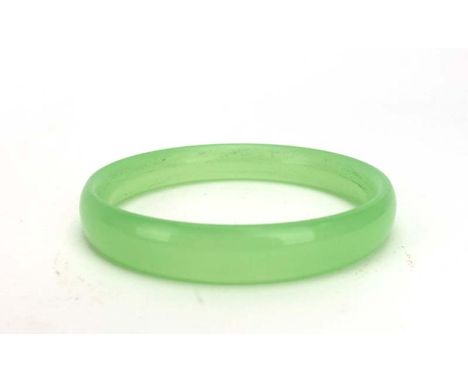 A pale green jade bangle, internal d. 6.4 cm