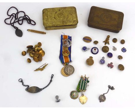 Two First World War Christmas tins containing a group of badges, silver and plated medallions, a Victory and 1914-1918 Medal 