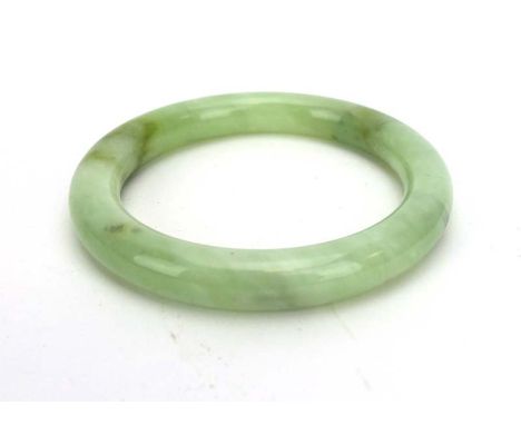 A pale green/white jade bangle, internal d. 5.9 cm CONDITION REPORT: No obvious chips, cracks or damage.  Please see addition