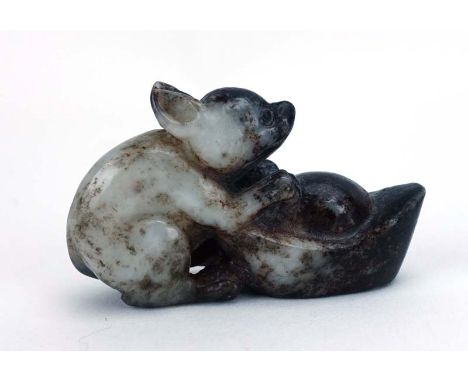 A Chinese brown/white jade carving modelled as a rat and sycee, h. 3 cm