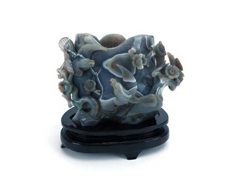 A Chinese banded agate brush pot relief carved with birds amongst blossoming branches on a lacquered stand, overall h. 21.5 c
