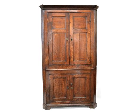 George III oak floor standing corner cupboard George III oak floor standing corner cupboard, moulded cornice above double two