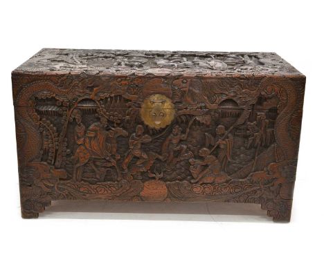 Chinese linen chest Early 20th-century Chinese camphor wood linen chest, heavily decorated with Dragons and figures, hinged l