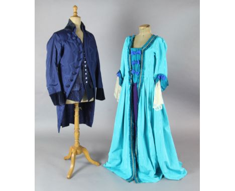 Cosi Fan Tutte: A rail with a blue and green, turquoise and green, gold and orange dresses, a blue velvet trimmed frock coat,