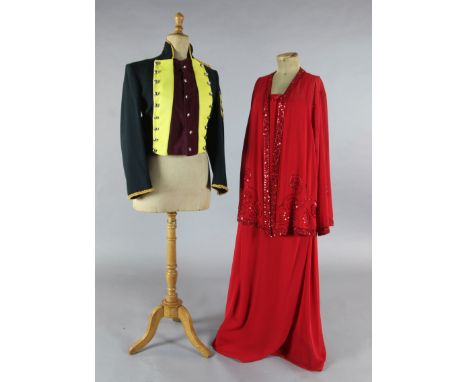 Tosca: A rail of yellow and maroon jackets, a red evening dress and jacket, white cotton nightdresses, a sheepskin waistcoat,
