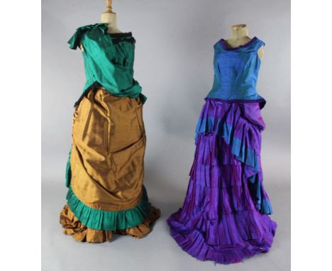 The Merry Widow: A rail with a purple and green dress, two similar dresses in green and brown and gold and orange, various bl