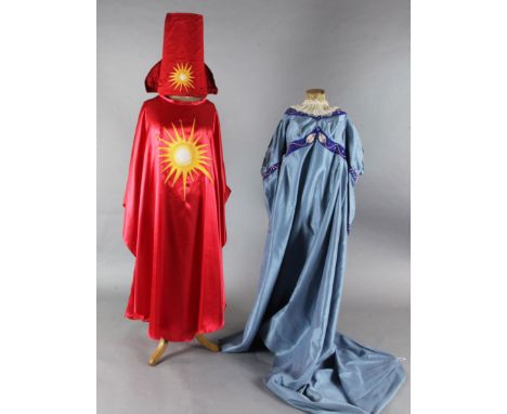 The Magic Flute: Two brightly coloured satin appliqué cloaks, a blue appliqué dress, two leather jackets, various waistcoats,