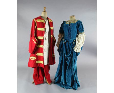 Lucia Di Lammermoor: A rail with a turquoise velvet and gold braided dress, a red and gold braided jacket, a petrol blue dres