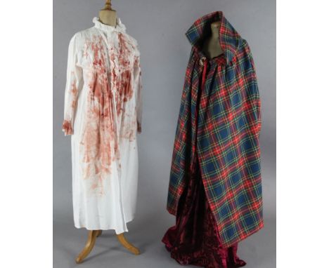 Macbeth: A rail with various tunics with Royal coat of arms, crosses, dragons, fleur d'Lys etc., blooded nightshirts, wool dr