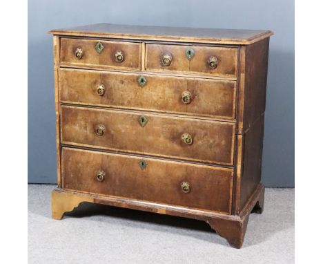 An 18th Century Walnut and Pine Sided Chest, the top with wide crossbanding, fitted two short and three long drawers with ban