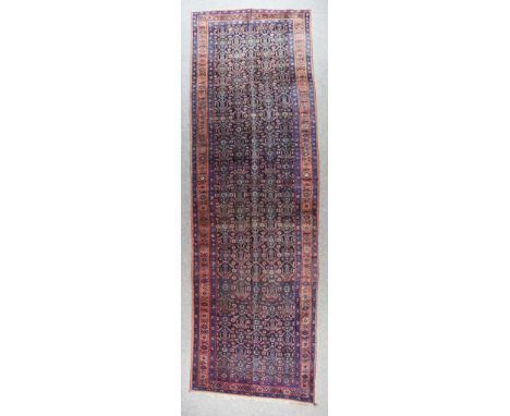 A Bidjar Runner, Early 20th Century, woven in colours, the field filled with stylised flowerheads and geometric motifs of rep