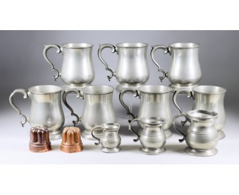 Eleven Pewter One Pint Tankards, with baluster shaped bodies and double scroll handles, 5ins high, a Victorian quart tankard 