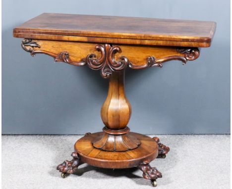 An Early Victorian Rosewood Rectangular Card Table, with rounded front corners, shaped apron carved with scroll ornament, on 