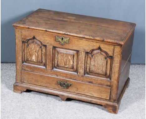 A Mid-18th Century Welsh Oak Coffer Bach, with plain lid, the front with central square fielded panel flanked by two shaped f