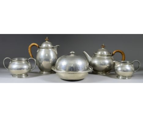 An Early 20th Century "Tudric" Hammered Pewter Four-Piece Tea Service, with circular bulbous bodies, comprising - tea pot and