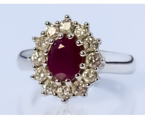 A Ruby and Diamond Ring, Modern, in 18ct white gold mount, the centre set with a ruby, approximate weight 1ct, surrounded by 