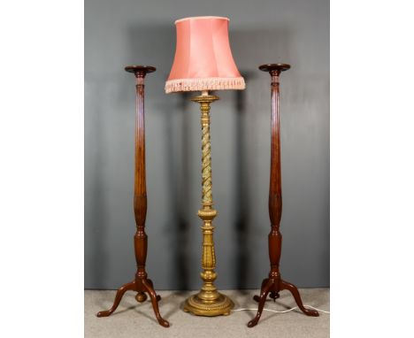 A Pair of Mahogany Tray Top Torcheres, the reeded columns with carved swag ornament, on tripod bases, 8.5ins diameter x 67ins