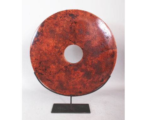 A LARGE CHINESE NEOLITHIC STYLE HARDSTONE BI DISC, together with a fitted metal display stand, the disc 15.75in diameter.