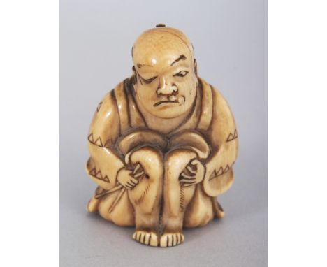 A JAPANESE MEIJI PERIOD IVORY NETSUKE OF A SEATED MAN, holding a pair of chopsticks to his side, 1.8in high.