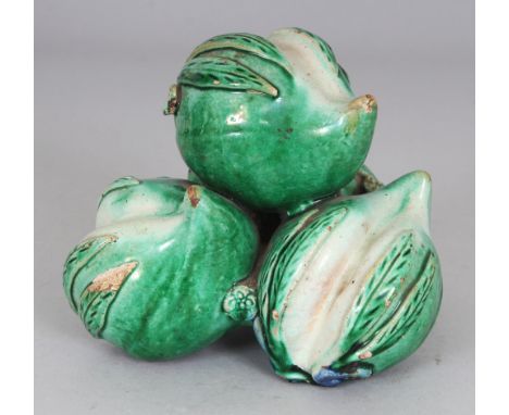 AN UNUSUAL 19TH/20TH CENTURY CHINESE FAMILLE VERTE CERAMIC GROUP OF THREE PEACHES, applied with green and blue glazes, 4.75in