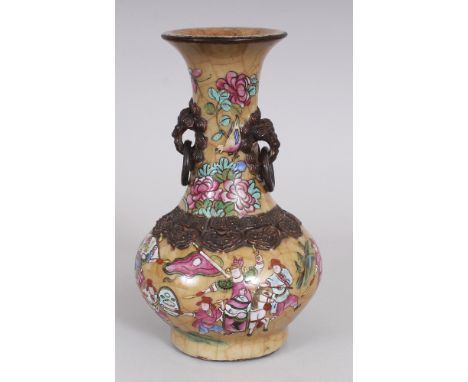 A CHINESE FAMILLE ROSE CRACKLEGLAZE PORCELAIN VASE, circa 1900, with loose ring handles, the sides painted on a beige ground 