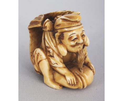 A SIGNED JAPANESE MEIJI PERIOD IVORY NETSUKE OF EBISU RIDING A GIANT CARP, the tail of the fish curving over the deity’s shou