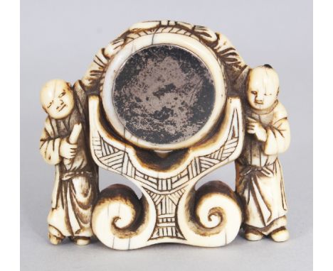 AN UNUSUAL JAPANESE SILVER-METAL INSET EDO PERIOD IVORY NETSUKE, carved in the form of two boys standing either side of a lar