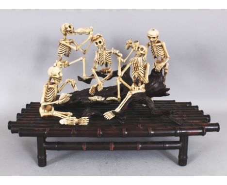 A VERY UNUSUAL LARGE SIGNED JAPANESE MEIJI PERIOD WOOD & IVORY OKIMONO OF A GROUP OF CAROUSING SKELETONS, drinking, smoking a