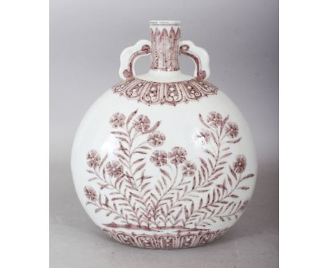 A CHINESE MING STYLE COPPER RED PORCELAIN MOON FLASK, each side decorated with a profusion of flowers, the base unglazed, 8.7